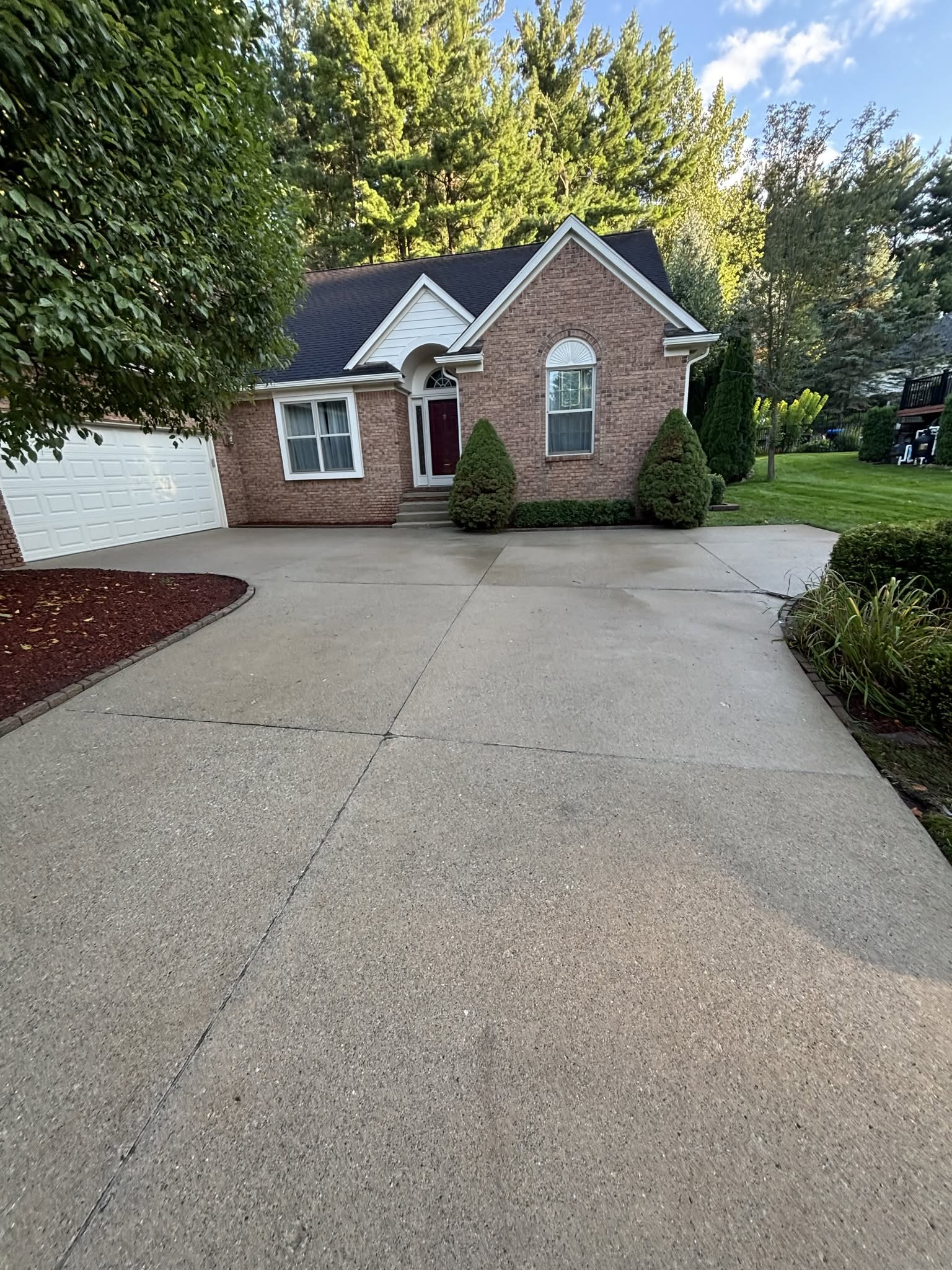 Finished concrete driveway for a brick home by Construction company Fenton, MI Jaybird Construction Finished concrete driveway for a brick home by Construction company Fenton, MI Jaybird Construction