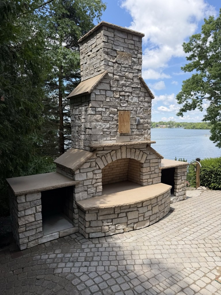 Chimney restoration in Fenton, MI — outdoor stone fireplace by Jaybird Construction LLC Outdoor stone fireplace and chimney restoration by Construction company Fenton, MI Jaybird Construction LLC